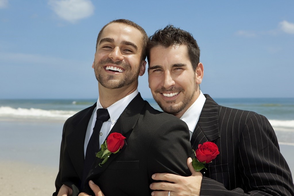 Two gay men after wedding on a beach